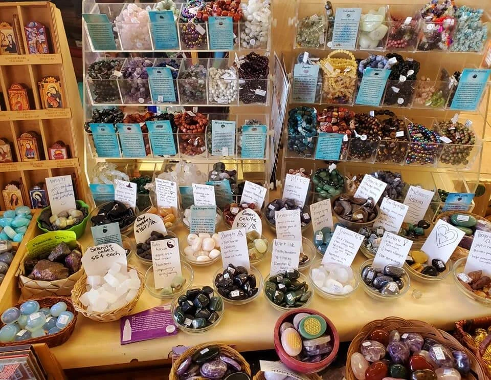A display of crystal gemstone bracelets and small gemstones