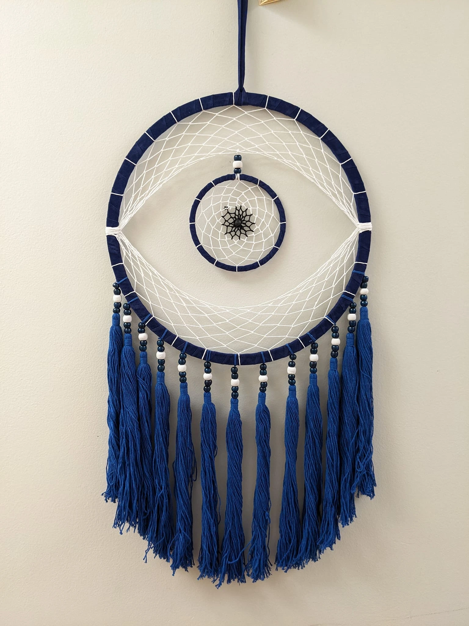 A large dreamcatcher in the shape of an evil eye symbol