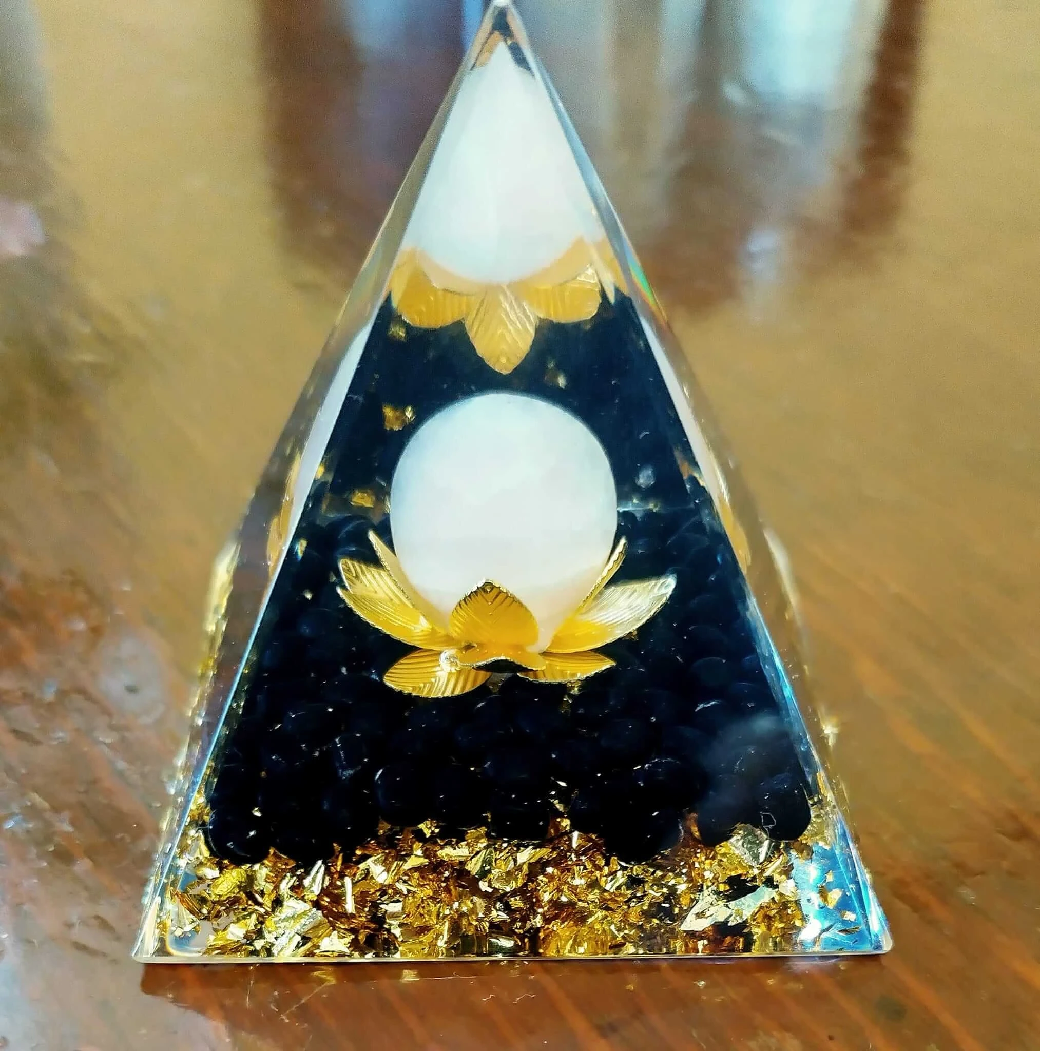 A pyramid of resin with crystal gemstones inside