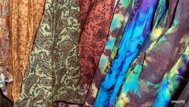 A display of various multicolored scarves